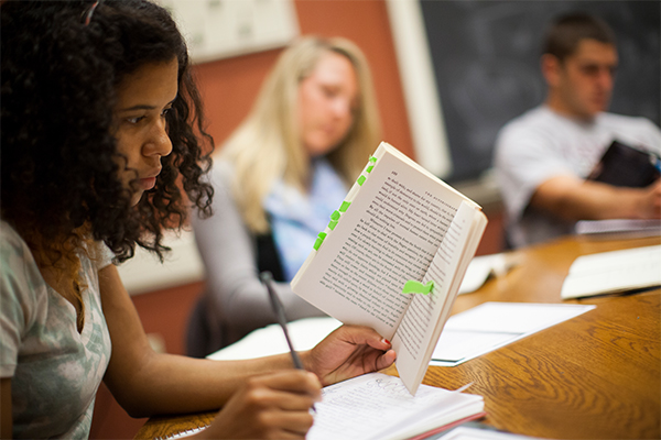 student in class with book