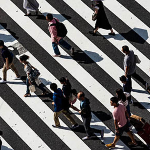 aerial view of people crossing the street